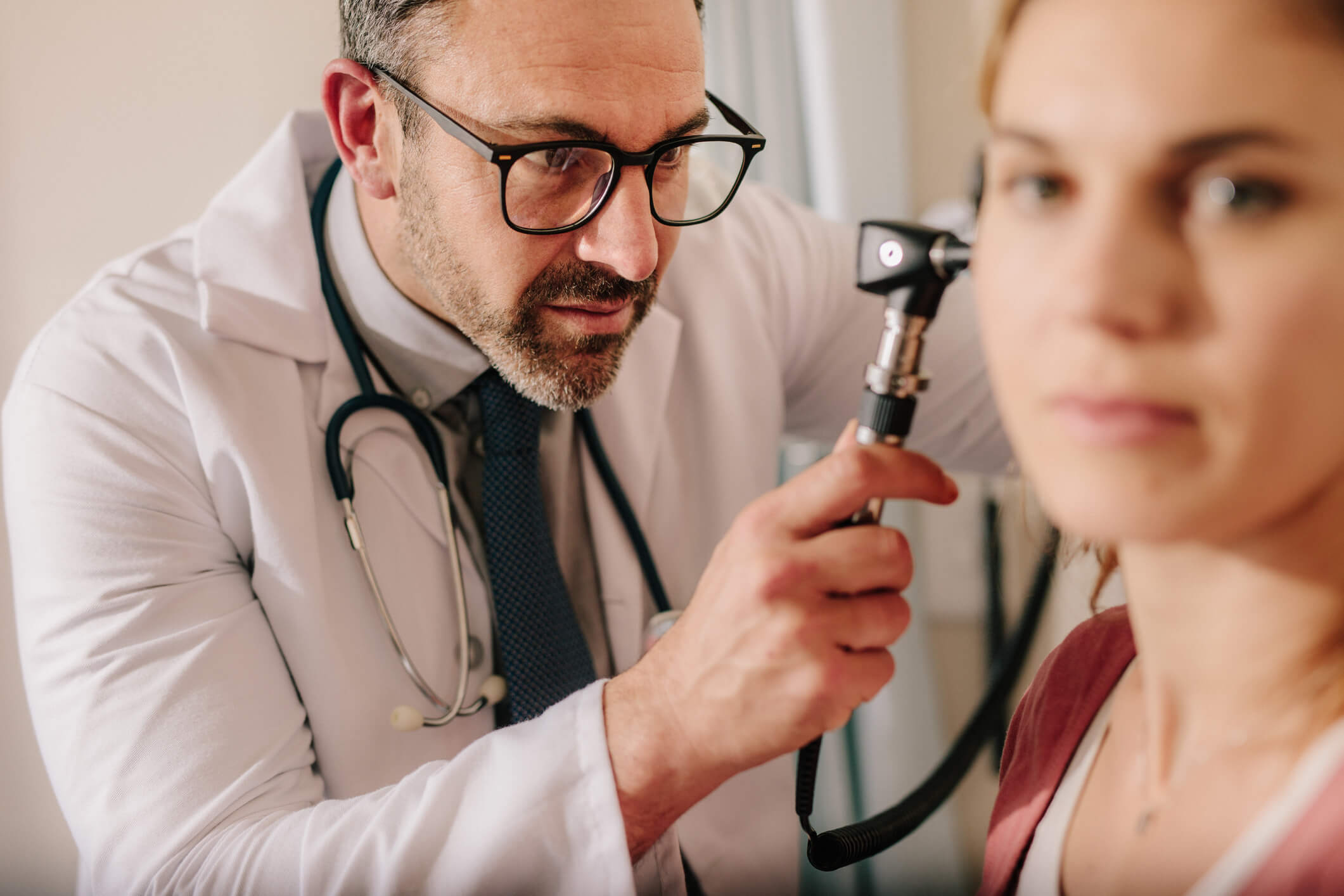 Doctor examining a patient's ear